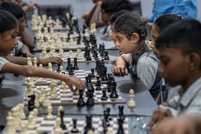 young child playing chess at a tournament