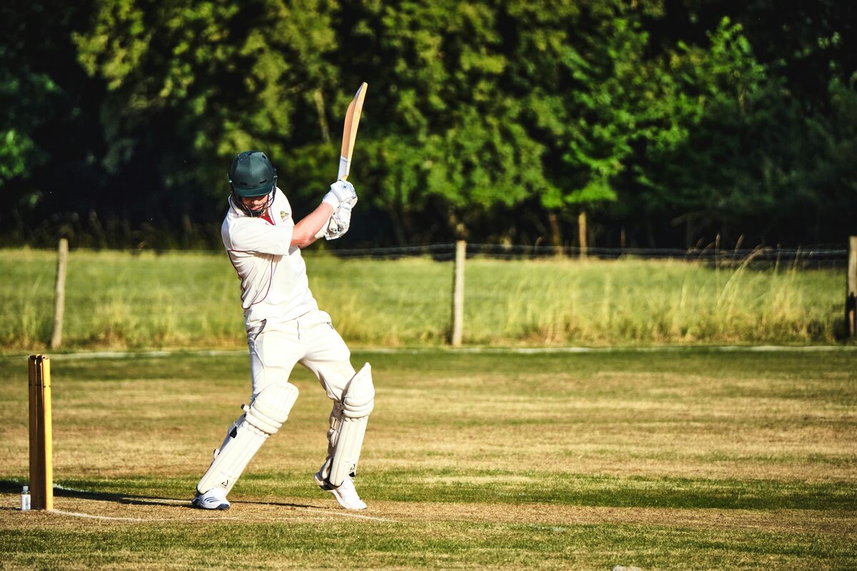 cricket batsman playing a shot in a stadium